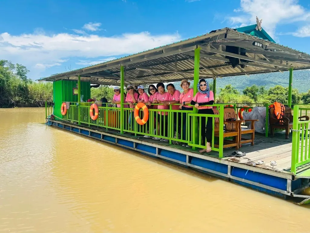 Happy family and friends enjoying a private barbecue and karaoke cruise experience on the river boat